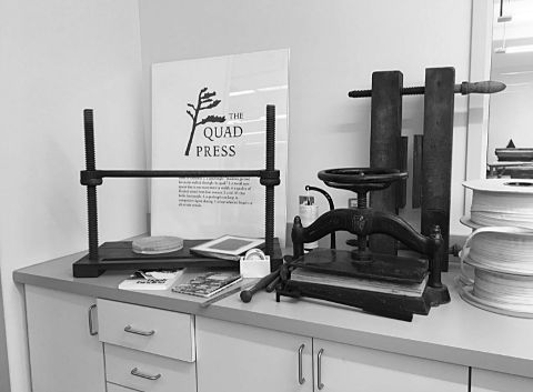 Sewing frames and book presses flank a poster on the newly minted MacOdrum Library imprint, The Quad Press